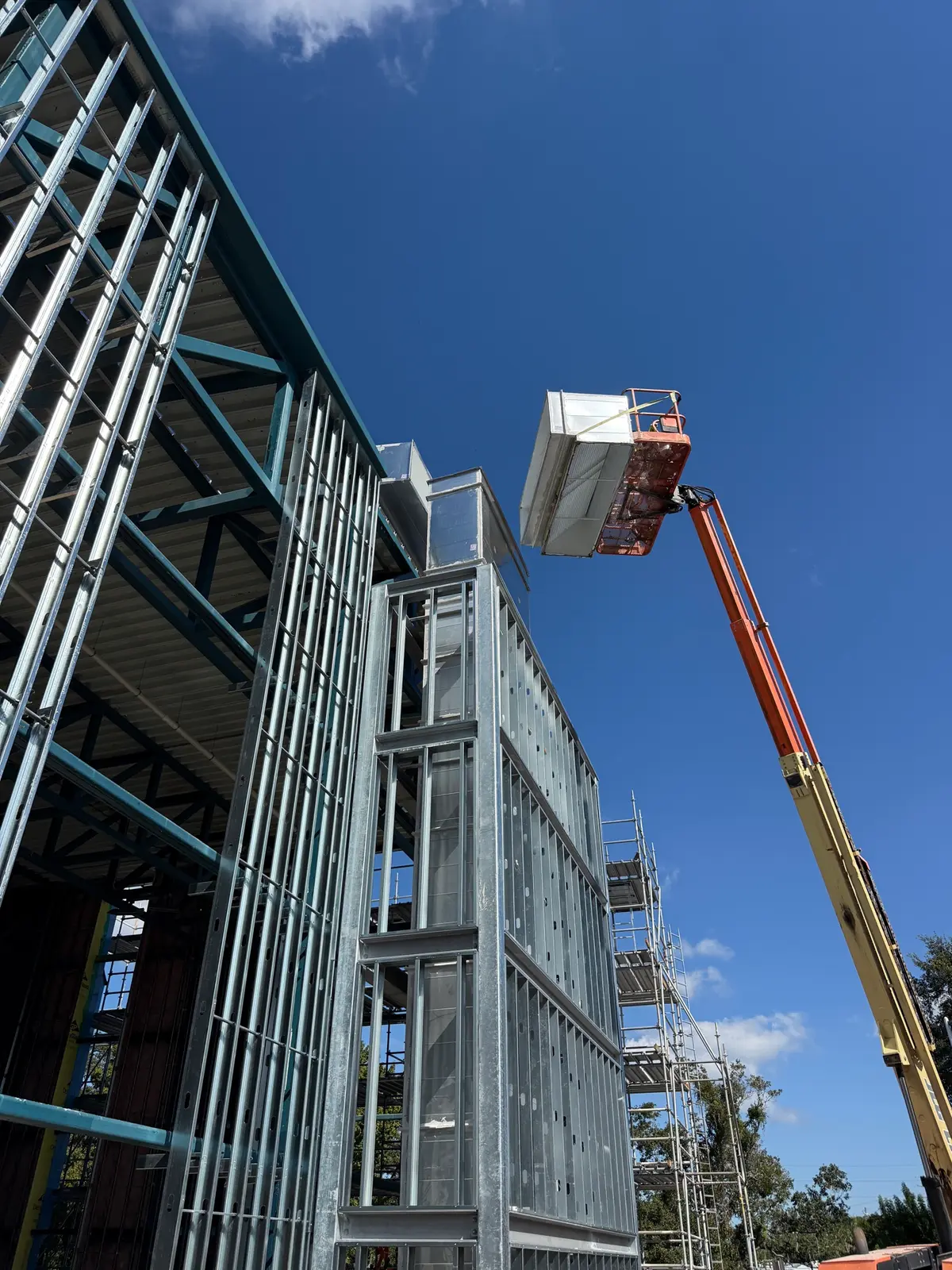 Boom lift placing equipment on the building envelope