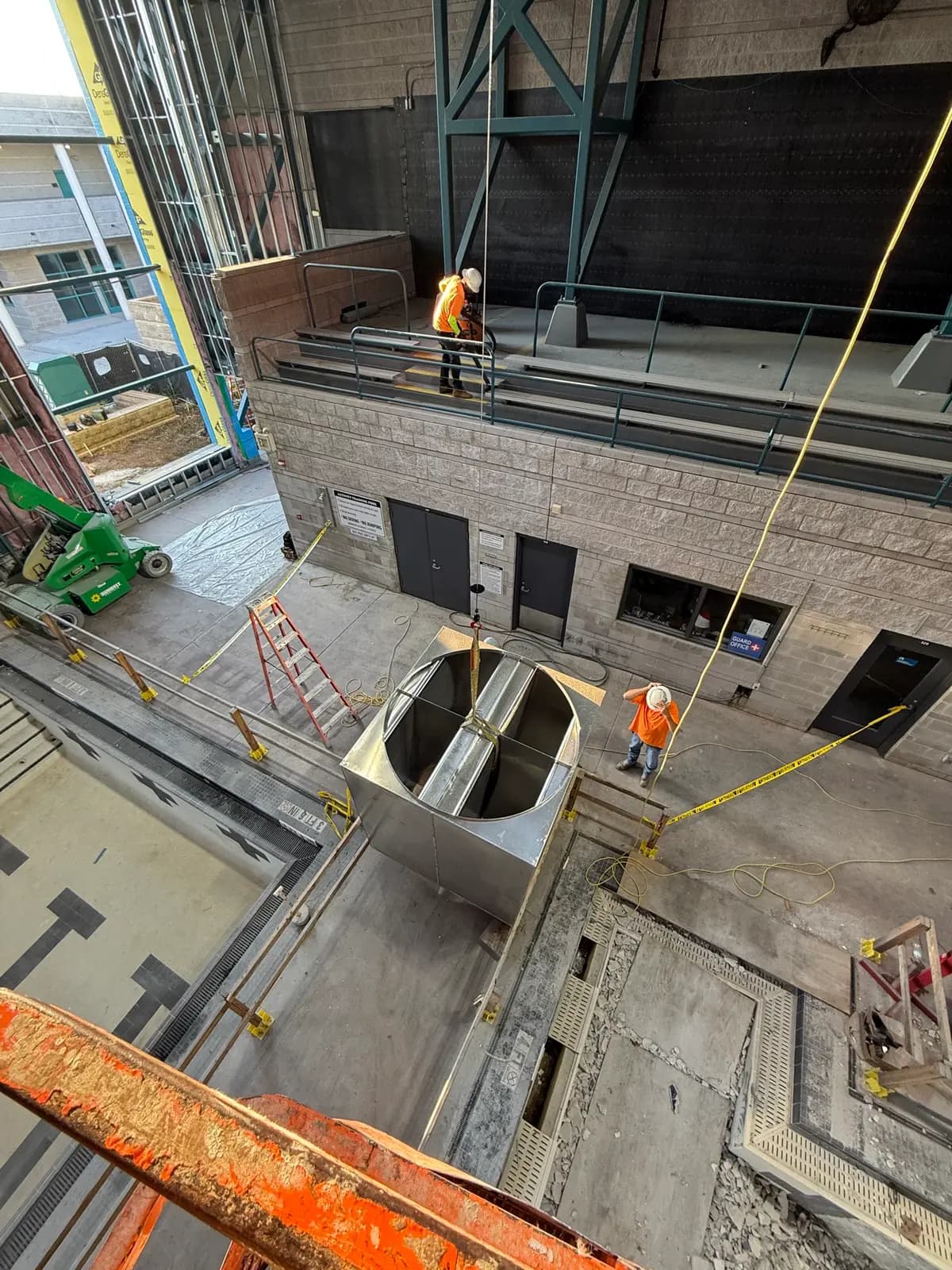 Crew setting a large duct riser in the aquatic complex