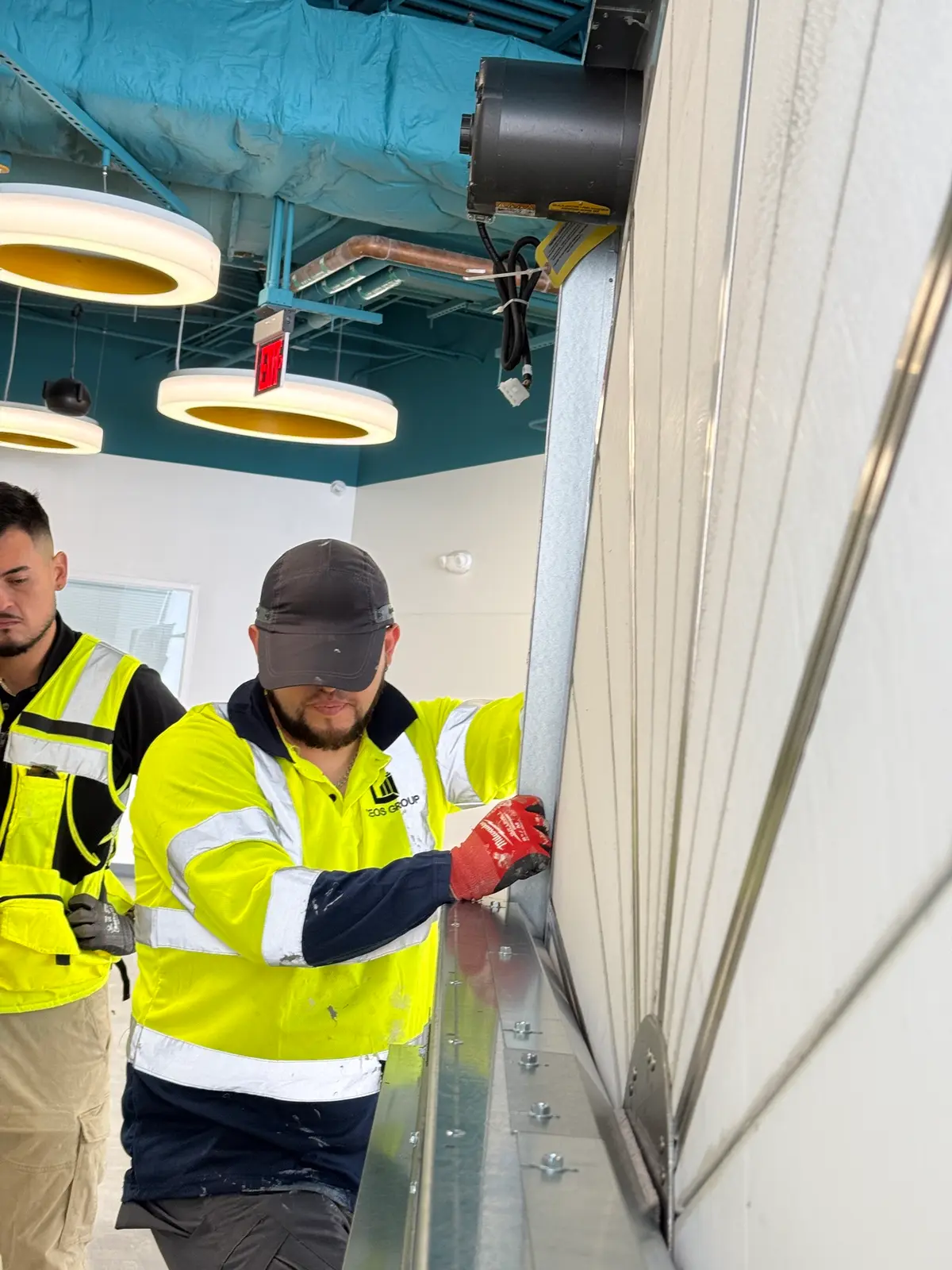 CEOS technicians fastening a plenum panel