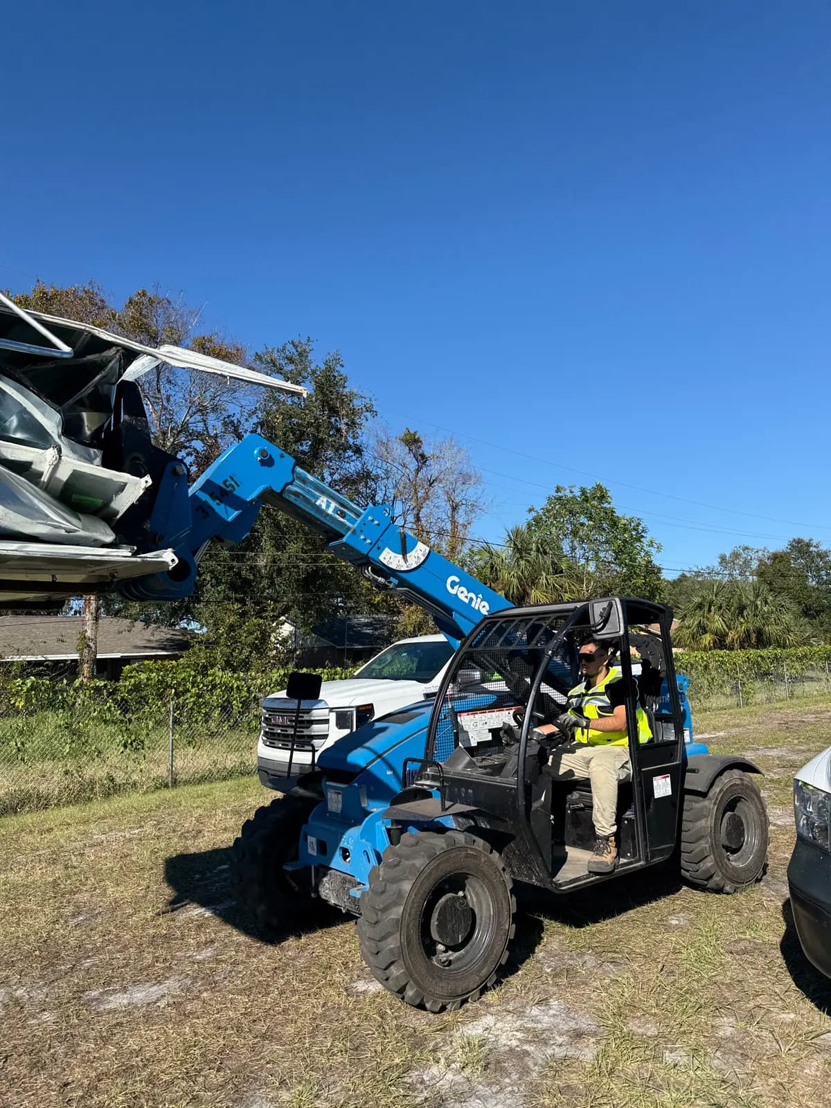 Telehandler moving HVAC equipment on site